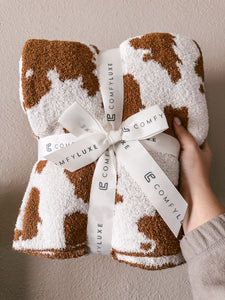 Brown cow print blanket